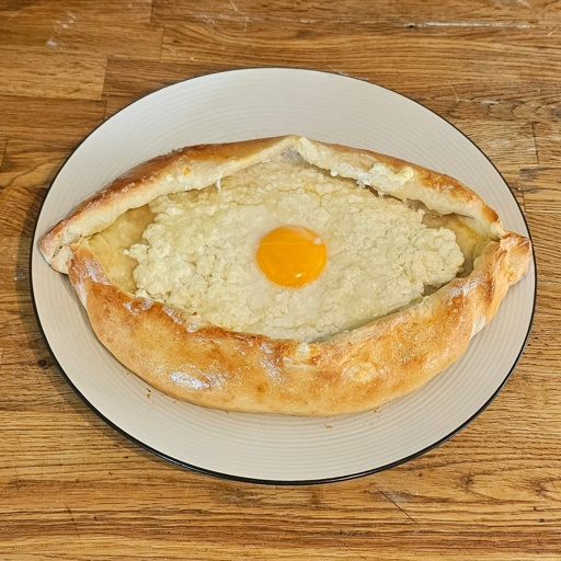 Fried bread in the shape of an eye, filled with cheese, with a barely set egg yolk in the center